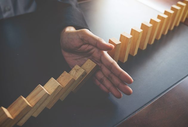 problem solving close up view hand business woman stopping falling blocks table concept about taking responsibility